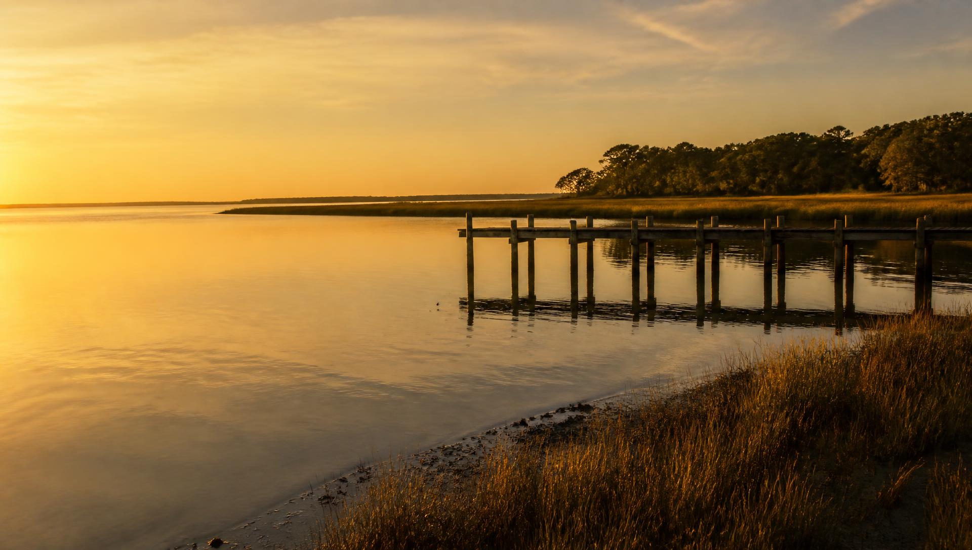 Vegapeake Bay at golden hour, a wooden pier reaching into still water